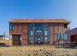 Custom Yankee Barn Home during framing and panel installation, showcasing early-stage construction in the build process
